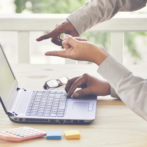 People pointing to a laptop screen