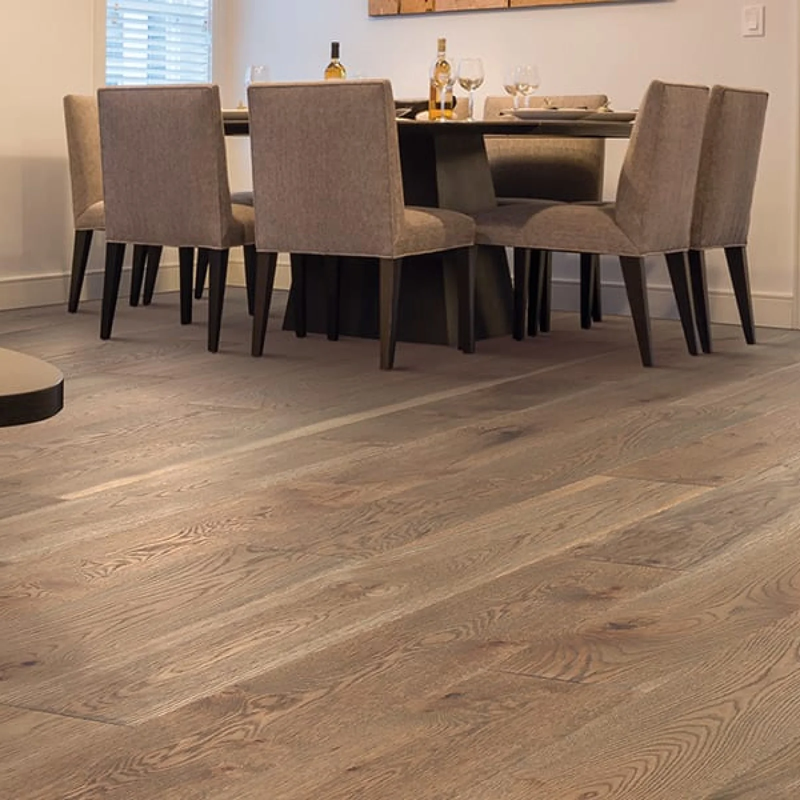 Wide plank hardwood installed in bright dining room