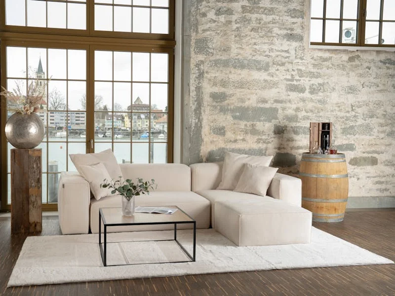 A sophisticated love seat in a room with beautiful hardwood flooring